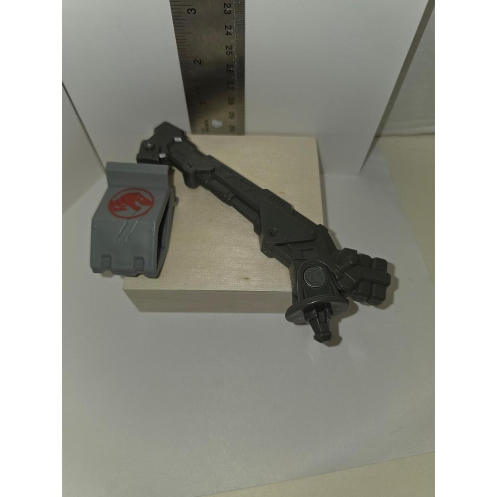 Jurassic World or similar action figure line, featuring a gray grapple-like arm